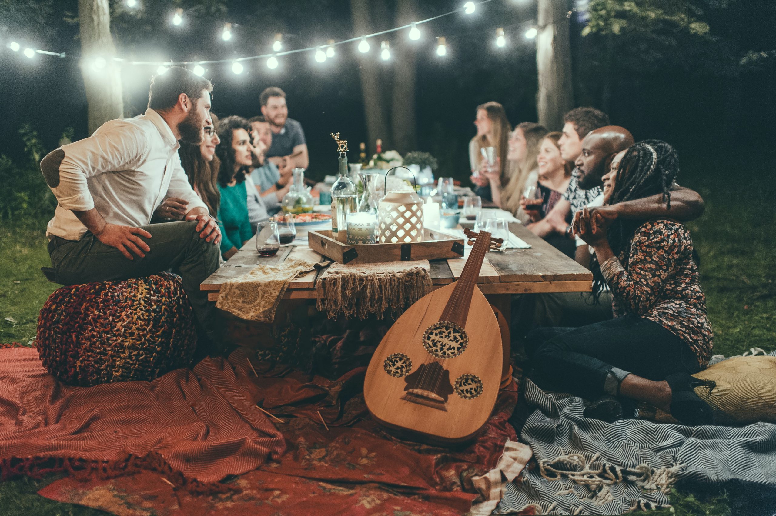 Roommates Gathering around a large dining table outdoors